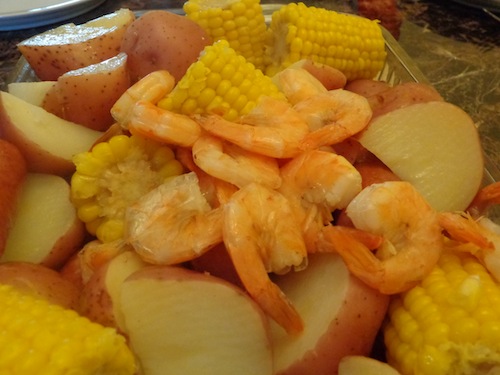Don't be intimidated by a shrimp boil! This Super Easy Shrimp Boil recipe uses frozen corn and fully cooked shrimp and sausage - definitely an easy dinner!