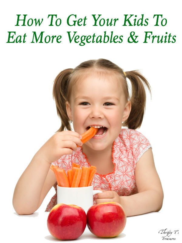 little girl eating carrots and apples