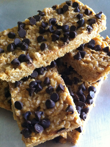stack of 4 chewy granola bars with chocolate chips on top