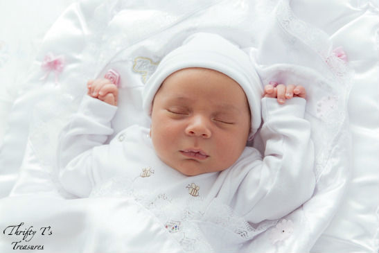 sleeping baby with white gown and cap