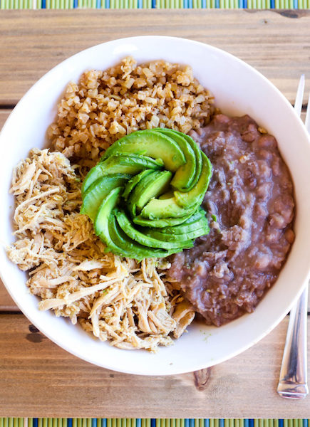 bowl of chicken, rice, beans and avocado flower