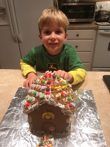 little boy with a gingerbread house