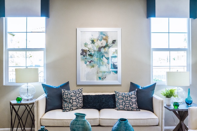 living room with white couch and blue accents